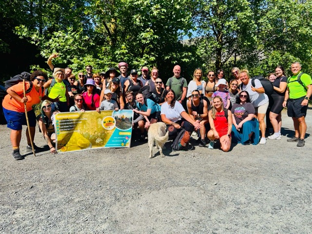 A summer group shot with the Nature Awareness banner, in woodland.
